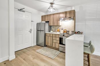 A kitchen with wooden cabinets and stainless steel appliances